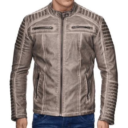 A man wearing a beige leather motorcycle jacket with a mandarin collar, zipper details, and embroidered patches on the arms and back.