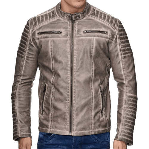 A man wearing a beige leather motorcycle jacket with a mandarin collar, zipper details, and embroidered patches on the arms and back.