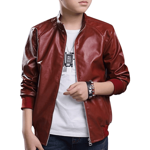 A child wearing a red leather motorcycle jacket with a white shirt underneath and black pants.