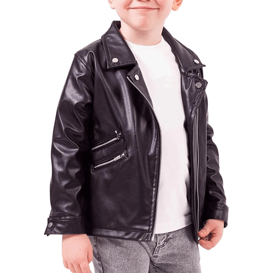 A young child wearing a black leather motorcycle jacket with a white shirt underneath. The jacket features a zipper and padding on the elbows, shoulders, and back.